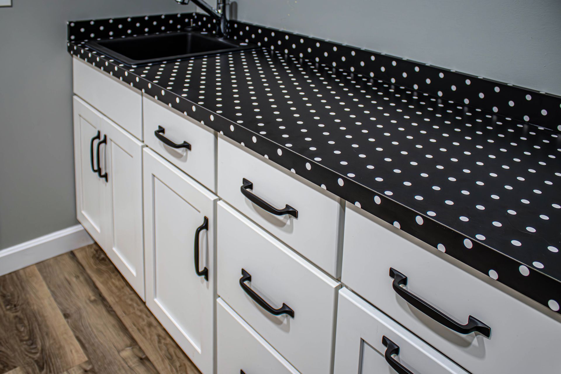 A kitchen counter with black and white polka dots on it.
