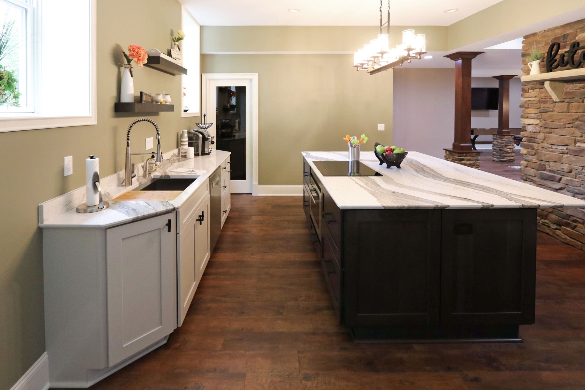 A kitchen with a large island and a sink.