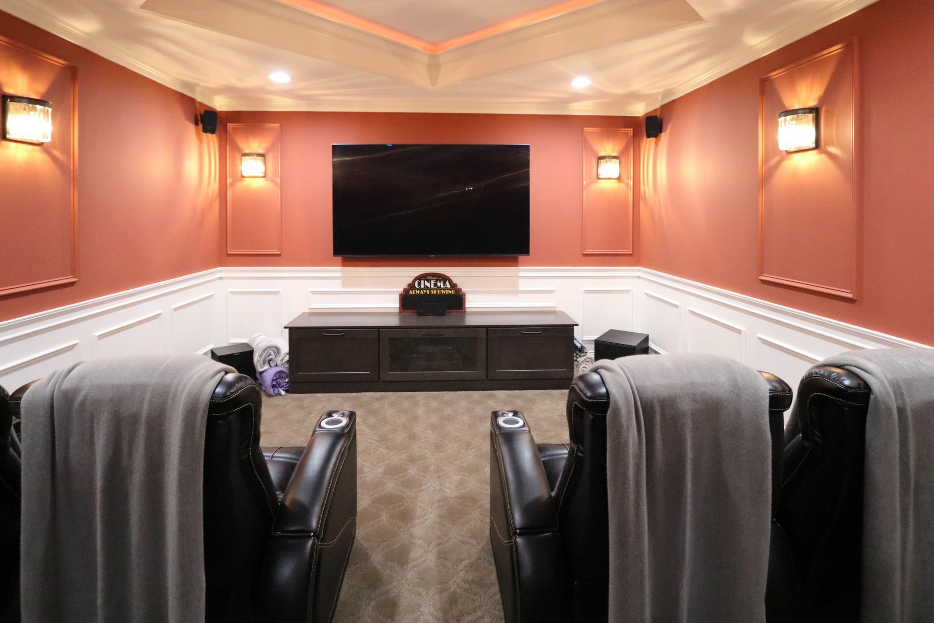 A home theater with two chairs and a flat screen tv.