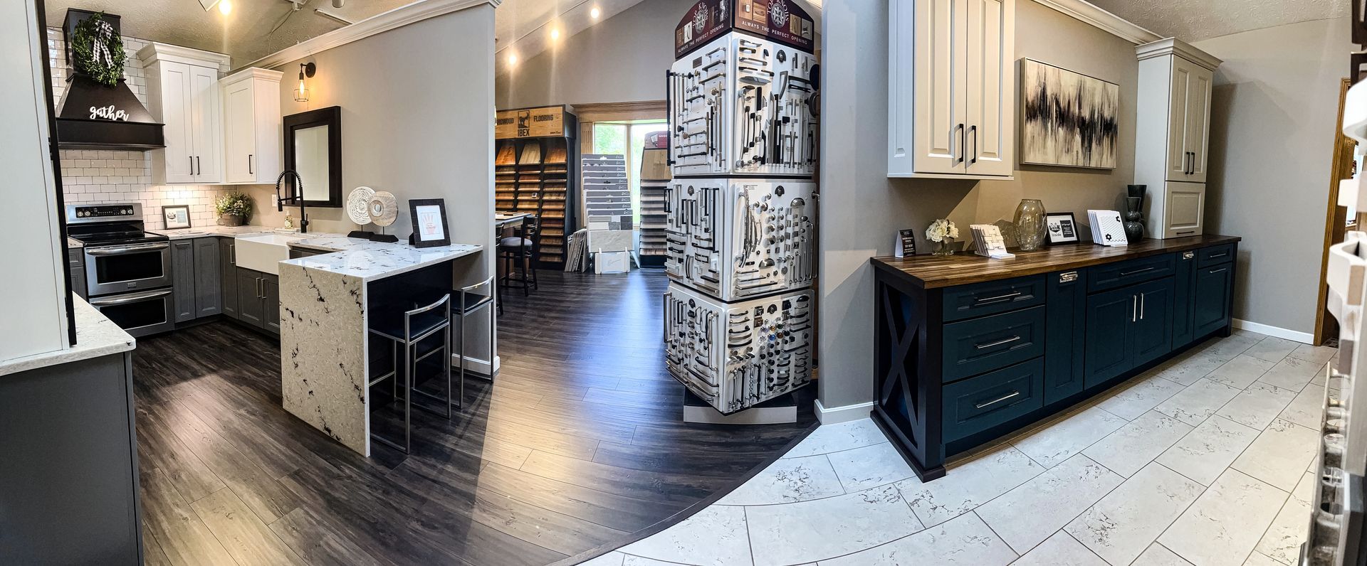 A kitchen with a lot of cabinets and counter tops in a showroom.