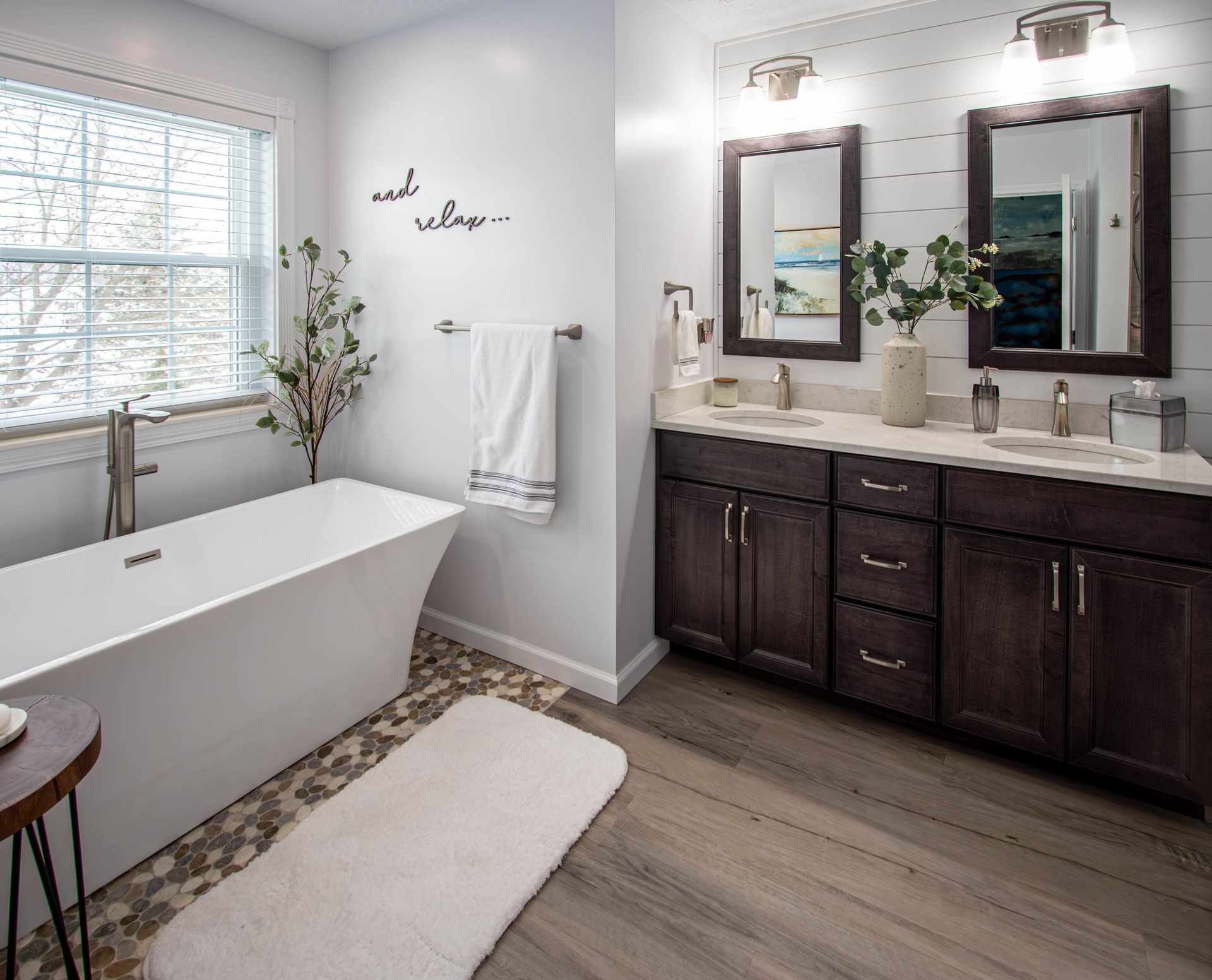 A bathroom with a bathtub , sinks , and mirrors.