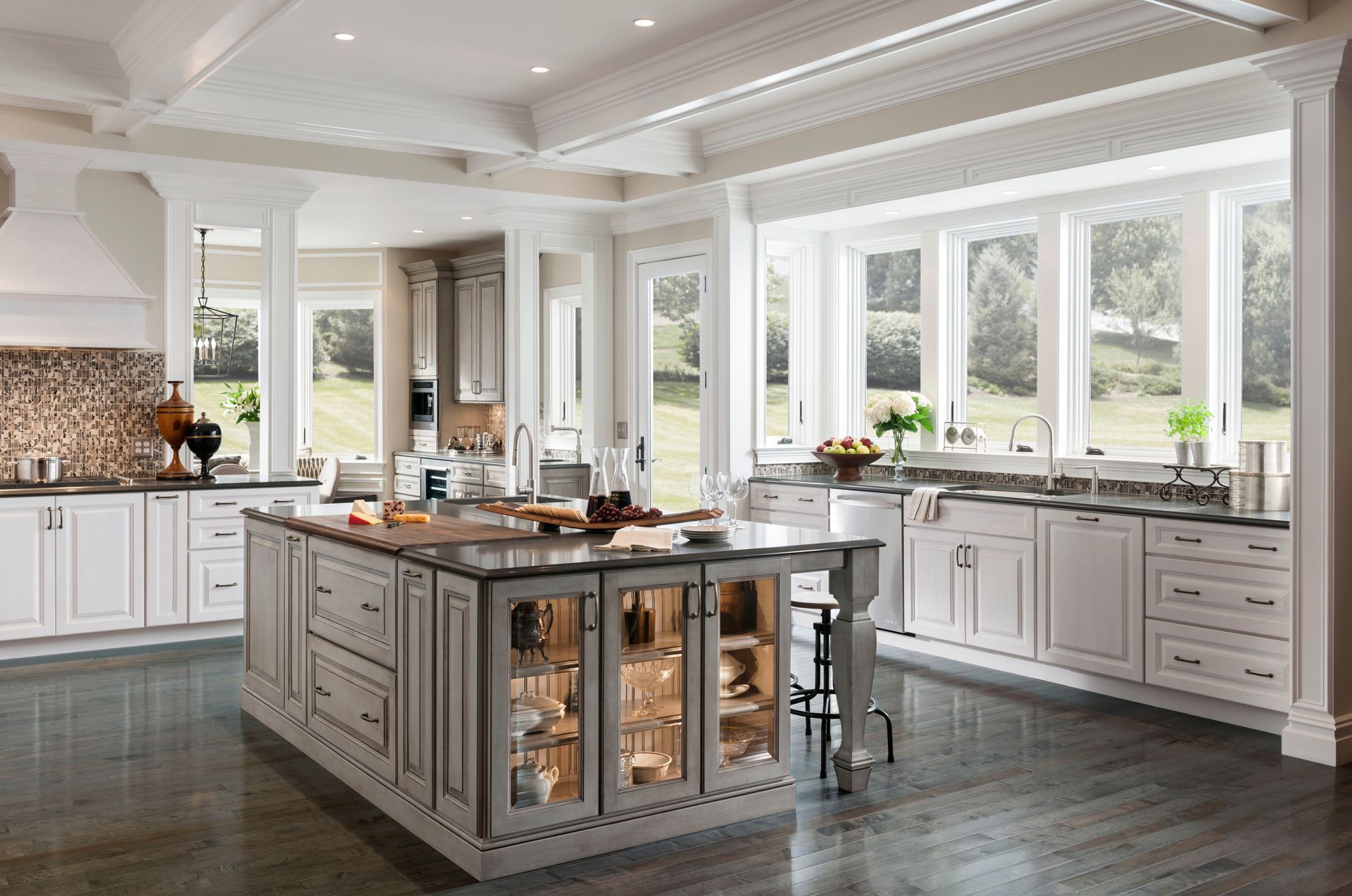 A large kitchen with white cabinets and a large island in the middle.