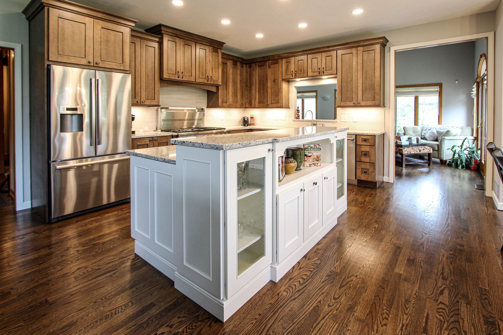 A kitchen with stainless steel appliances and a large island in the middle.