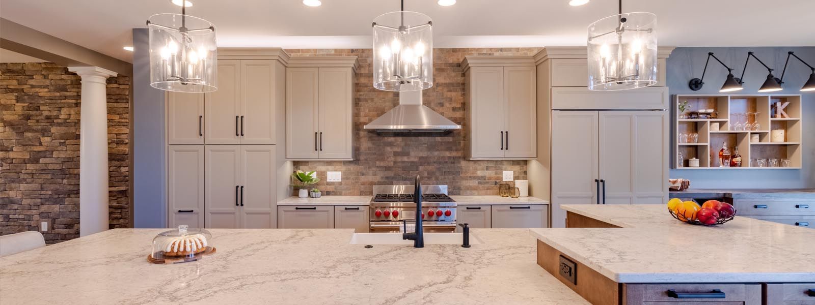 A kitchen with a large island and a sink.