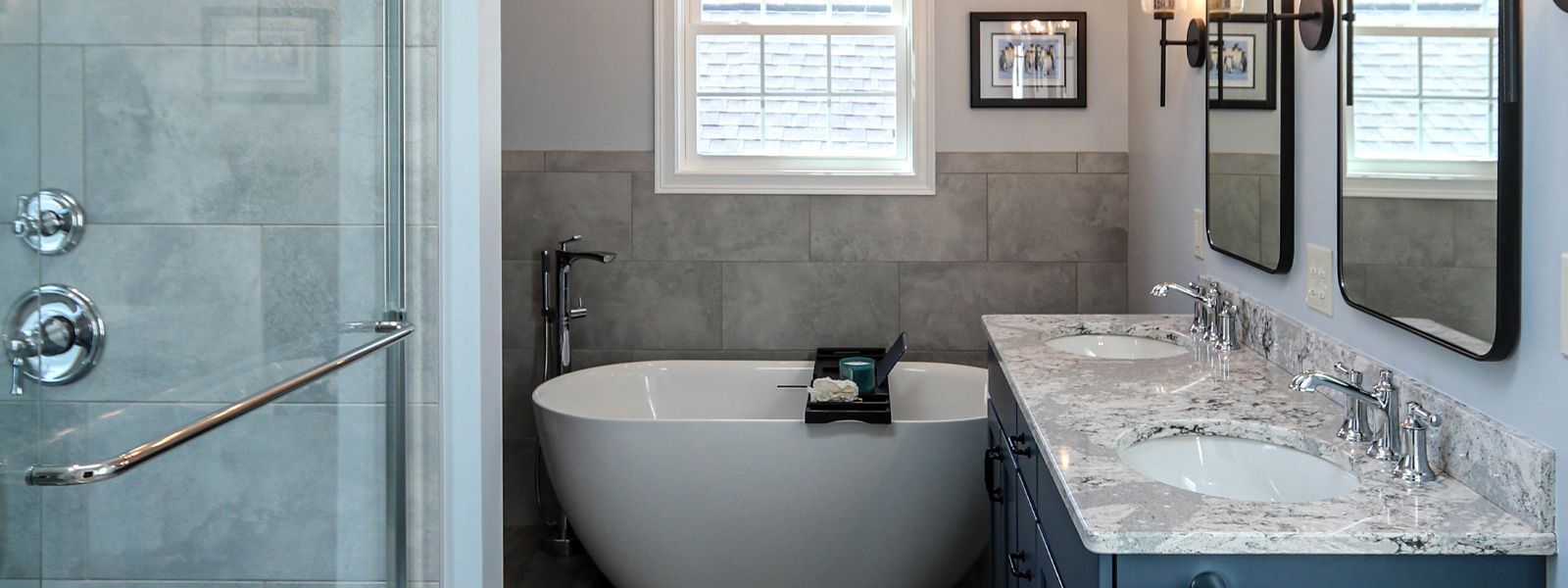 A bathroom with two sinks , a tub and a shower.