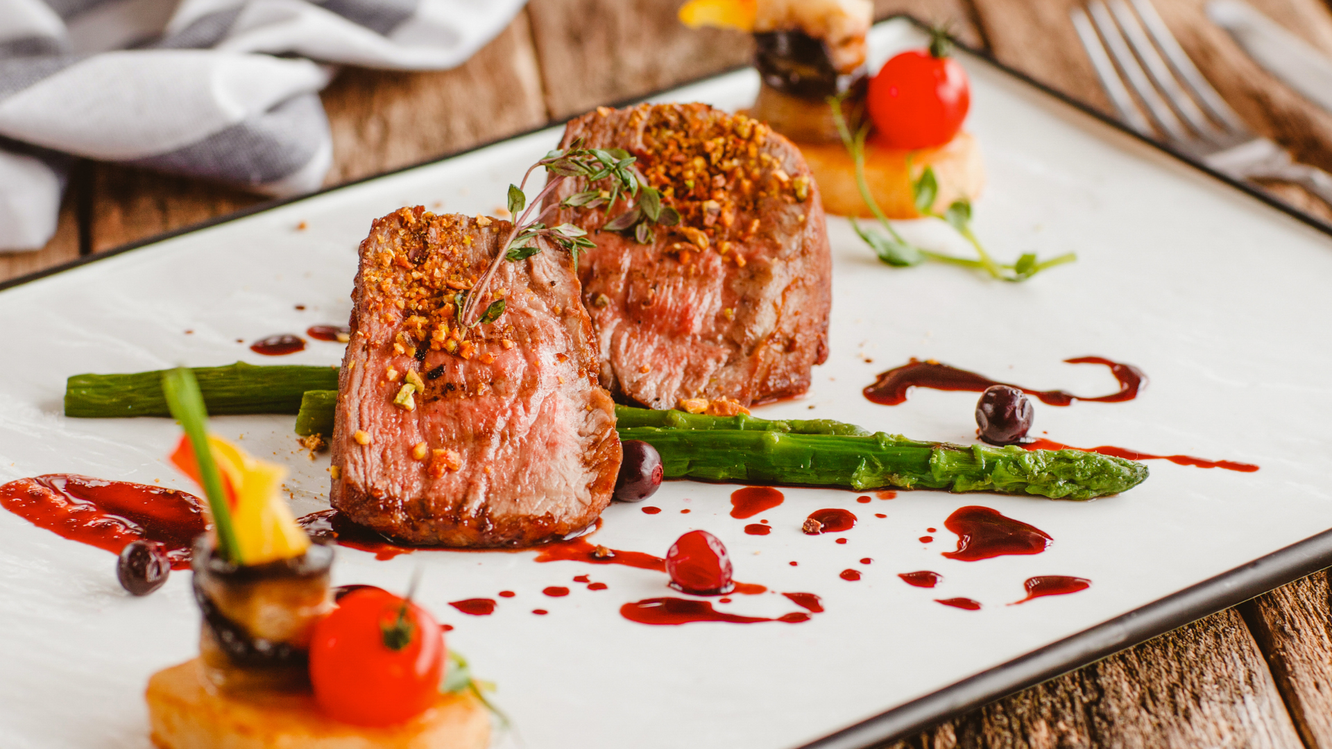 two slices of bread with butter and herbs on a wooden cutting board .