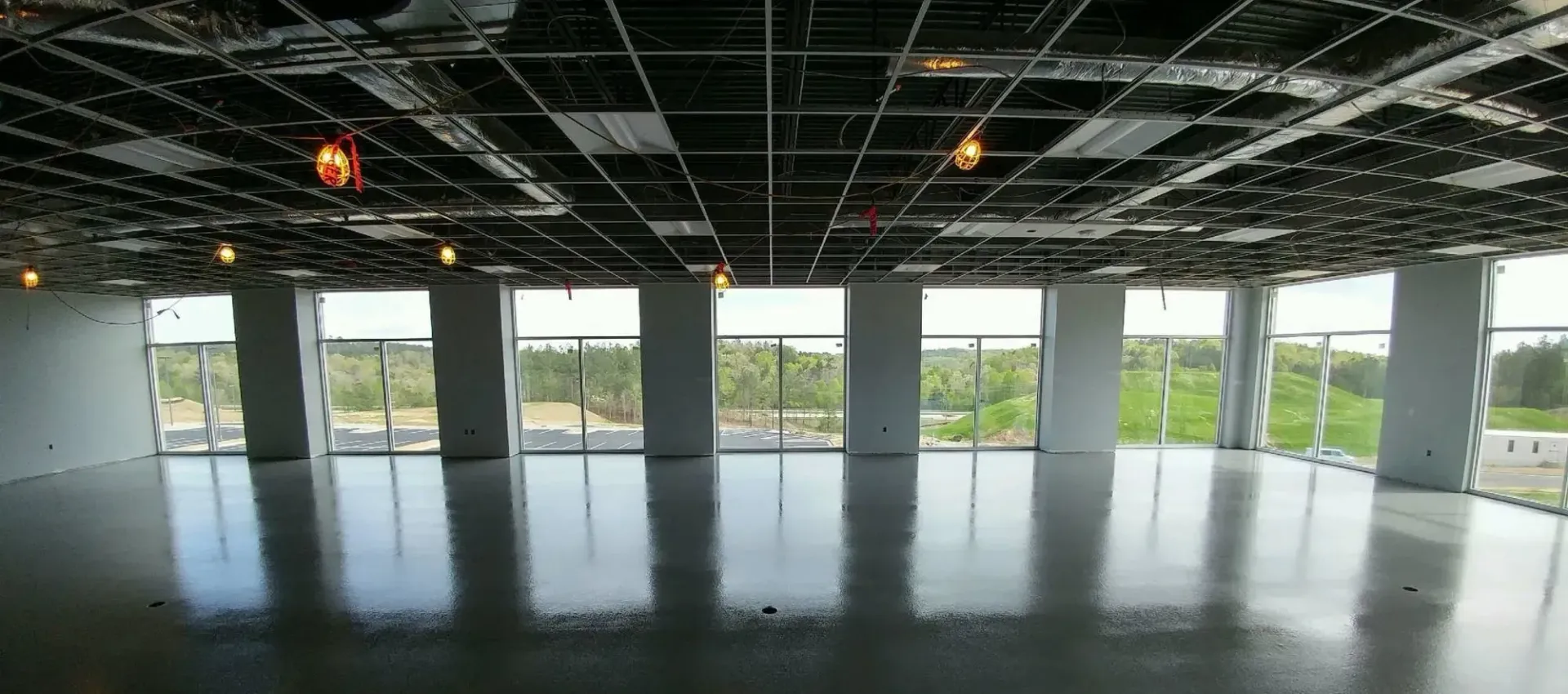 A large empty room with a lot of windows