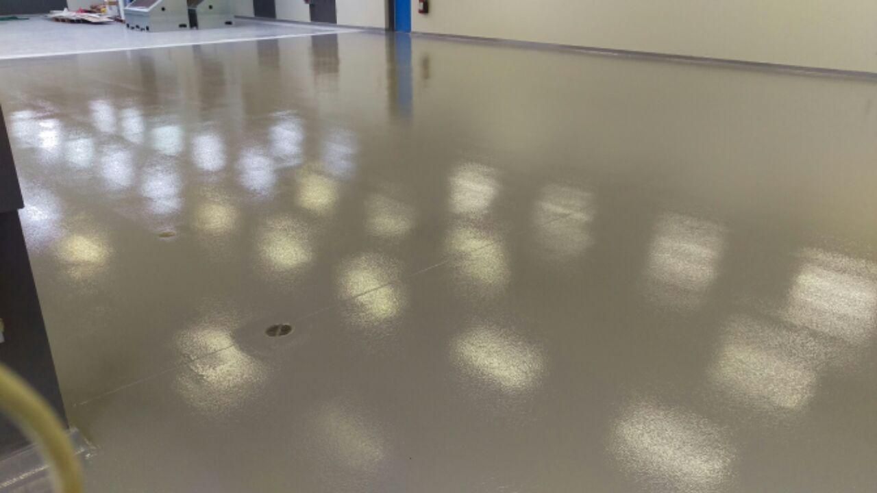 A close up of a shiny concrete floor in a room.