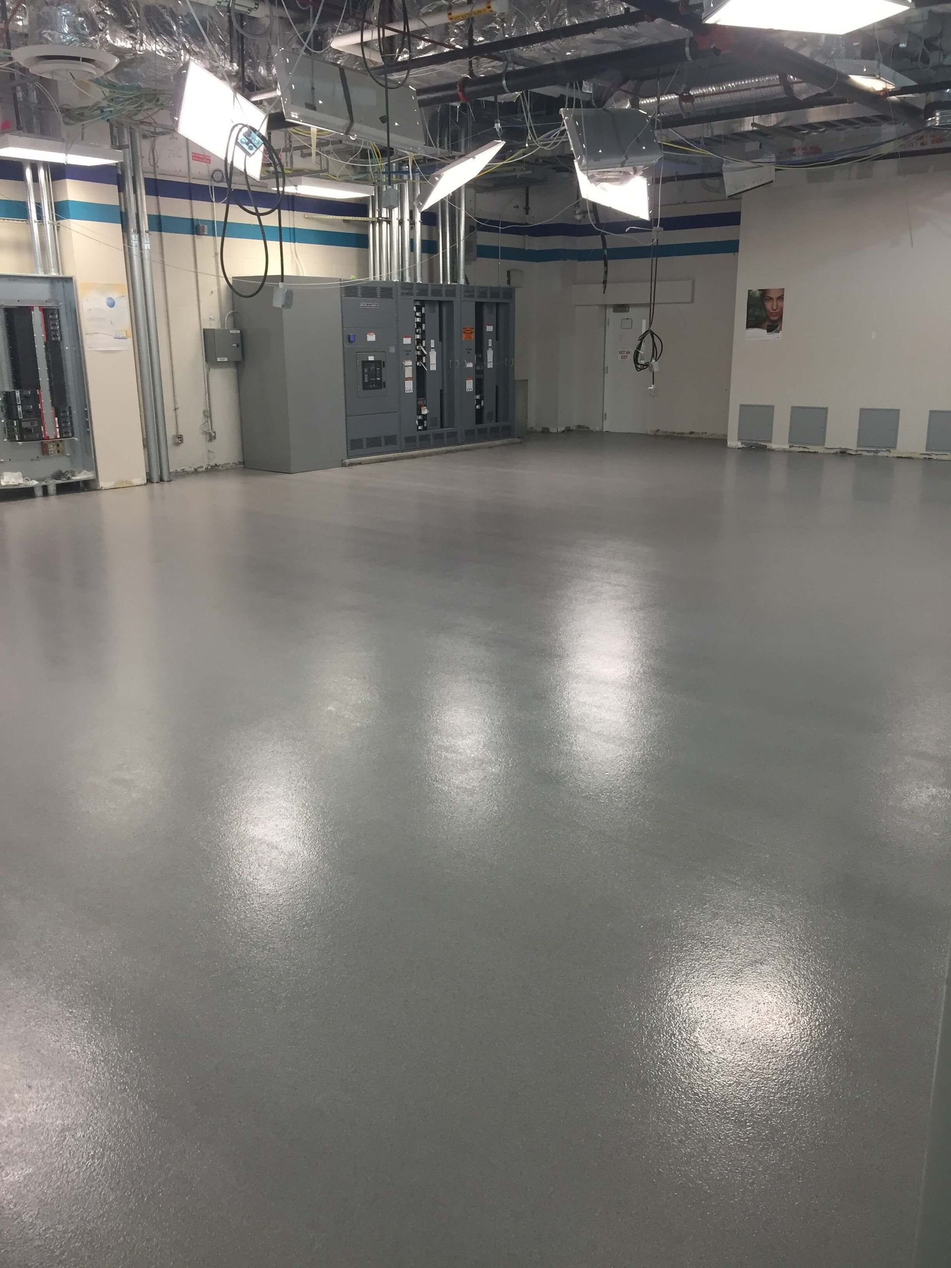 A large room with a gray floor and white walls.