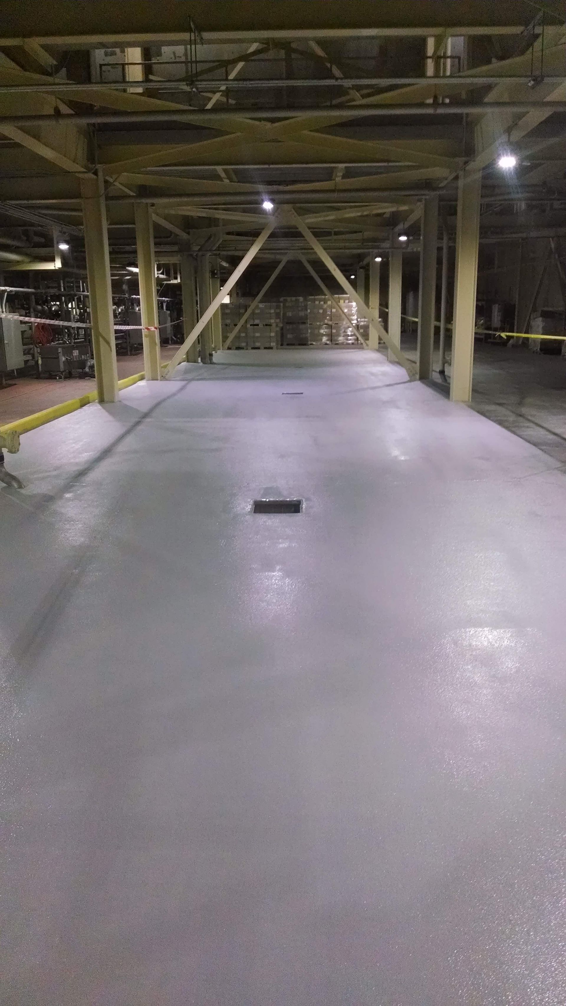 A large empty parking garage with a concrete floor.