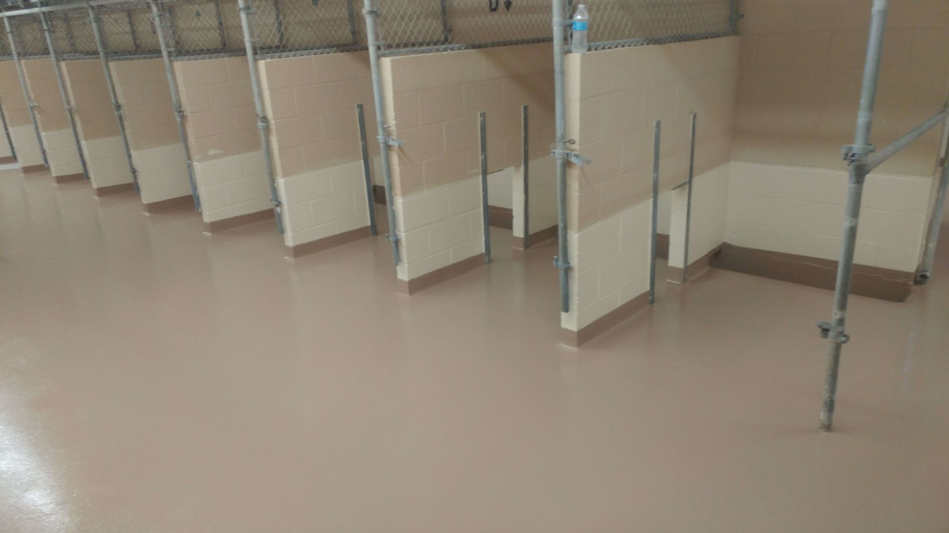 A row of cubicles in a bathroom under construction.