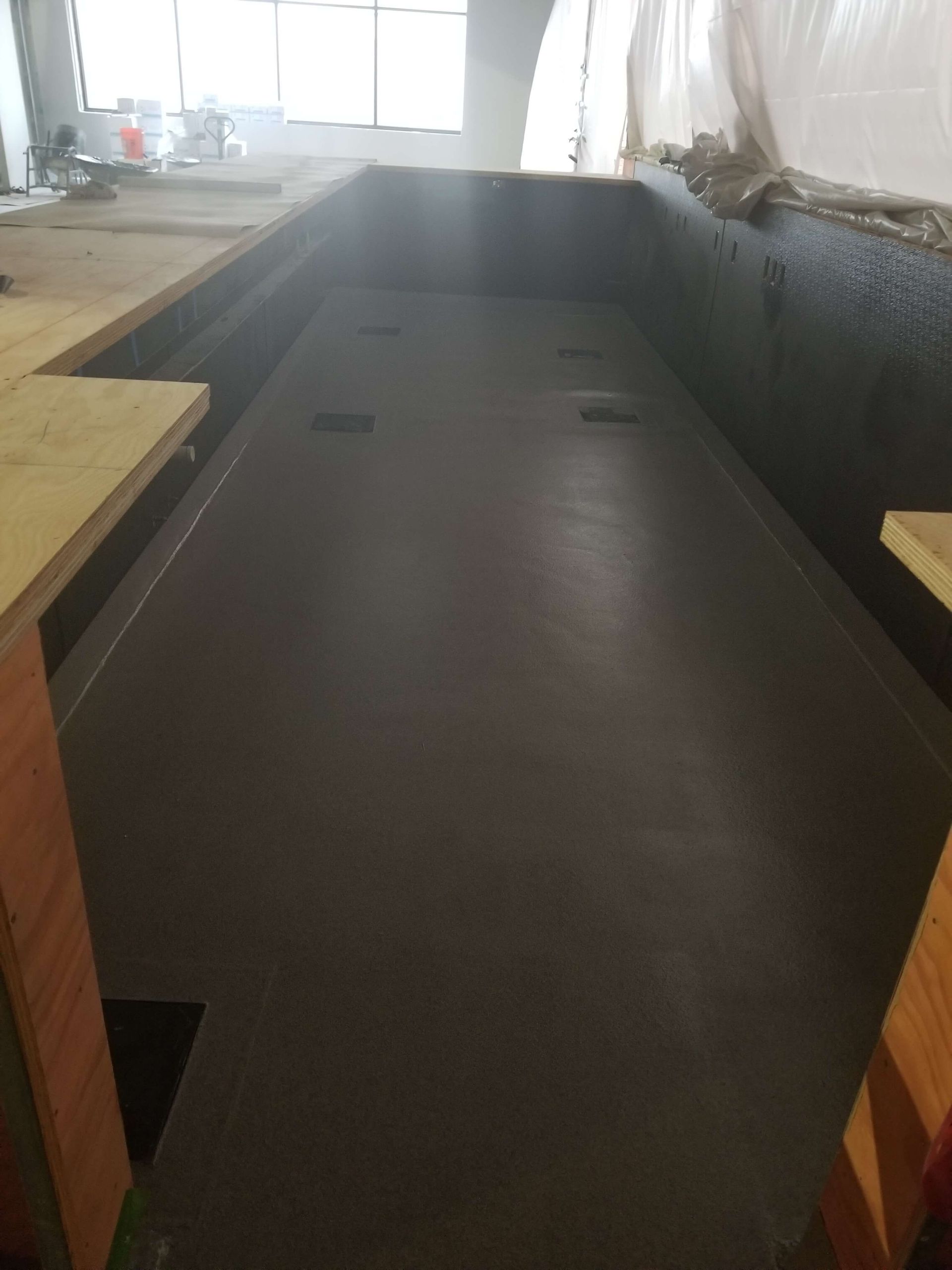 A large swimming pool is being built in a building.