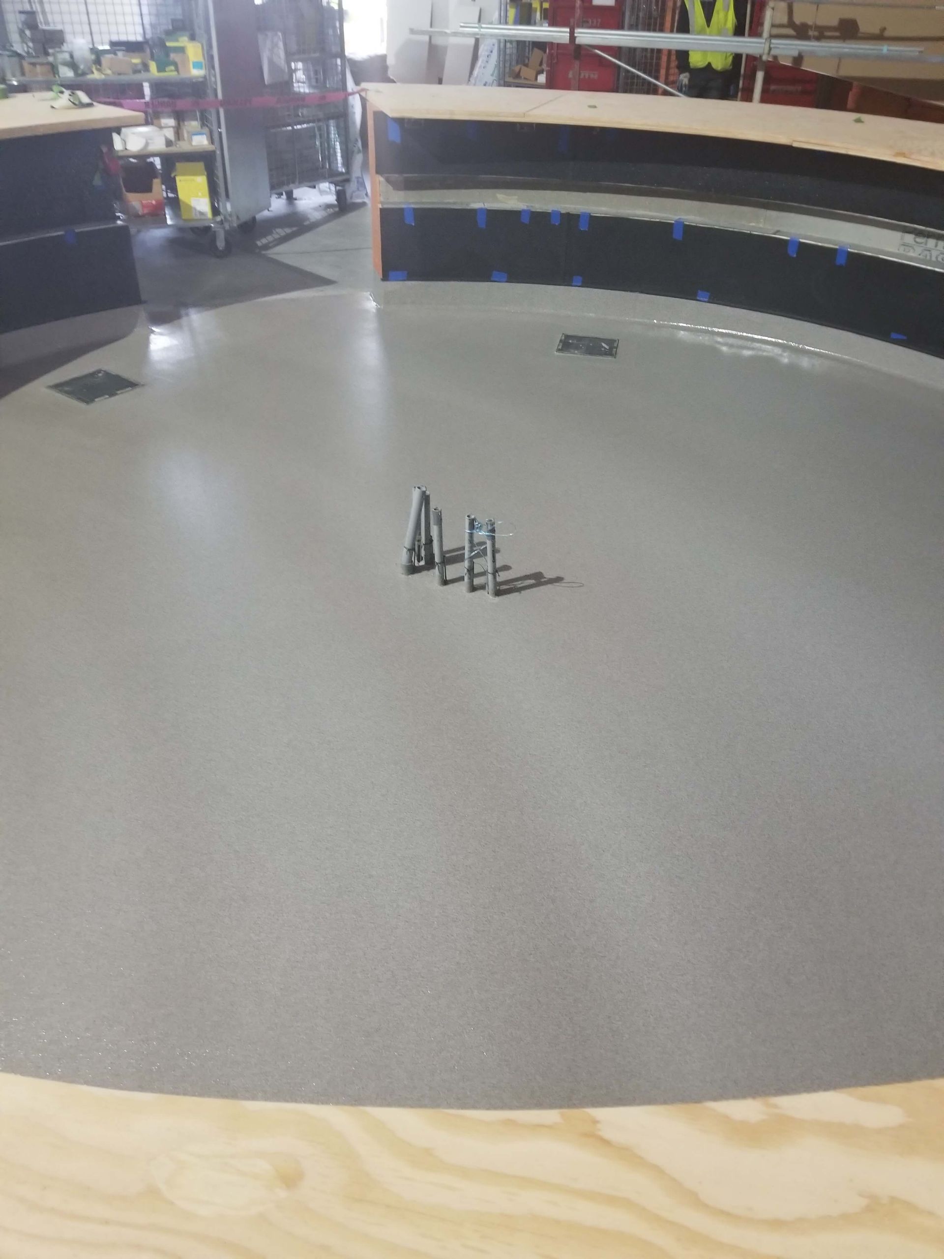 A round table with a bunch of screws on it in a room.