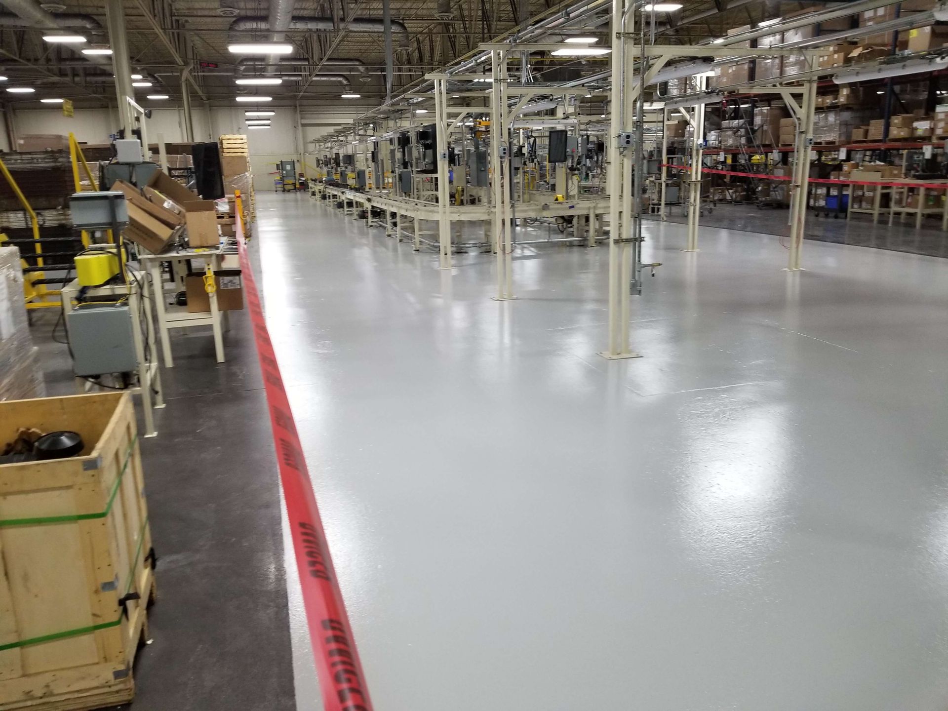 A large warehouse filled with lots of machinery and boxes.