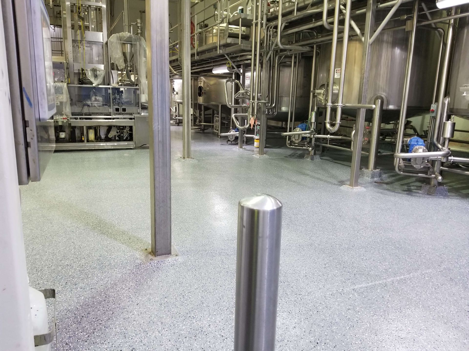 A factory with a stainless steel pole in the middle of it.