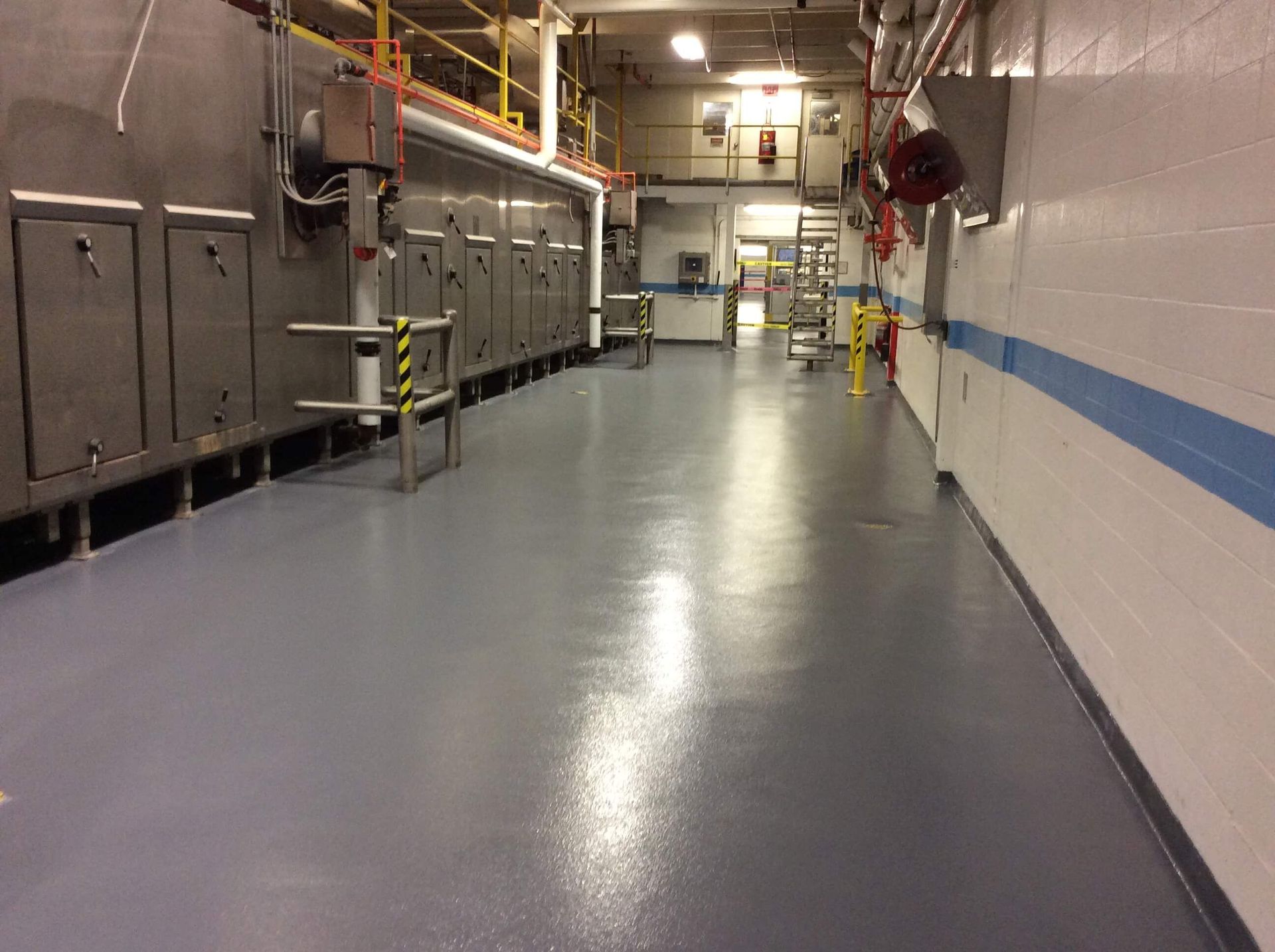 A large room with a gray floor and white walls.