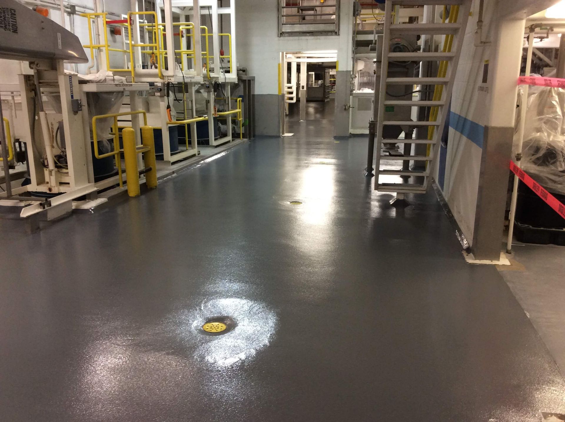 A large room with a lot of machinery and stairs.