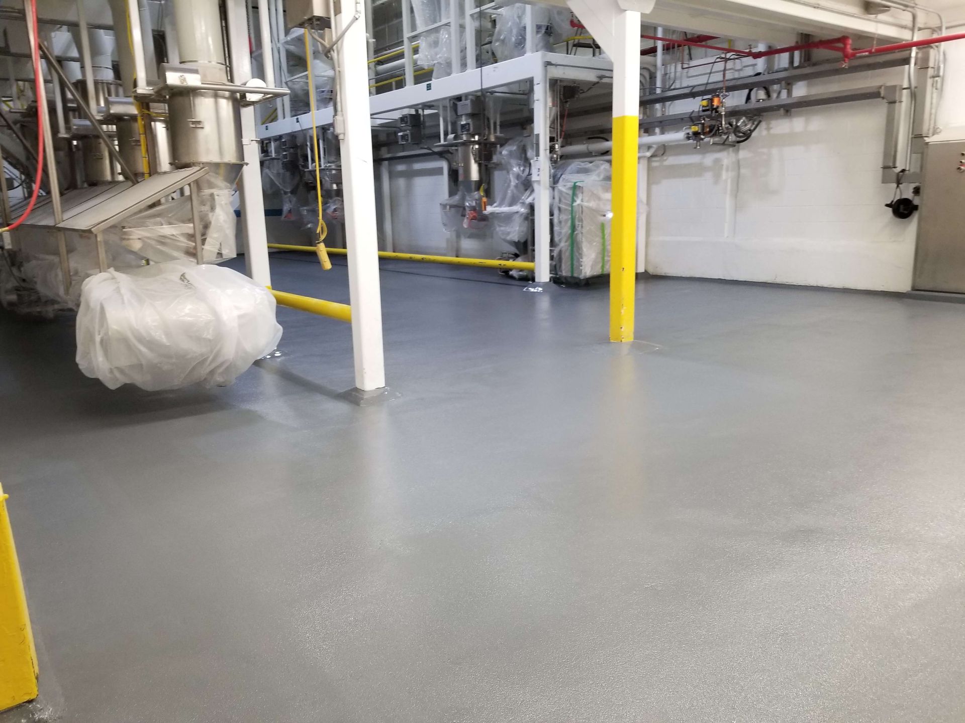 A large room with a lot of pipes and machinery in it.