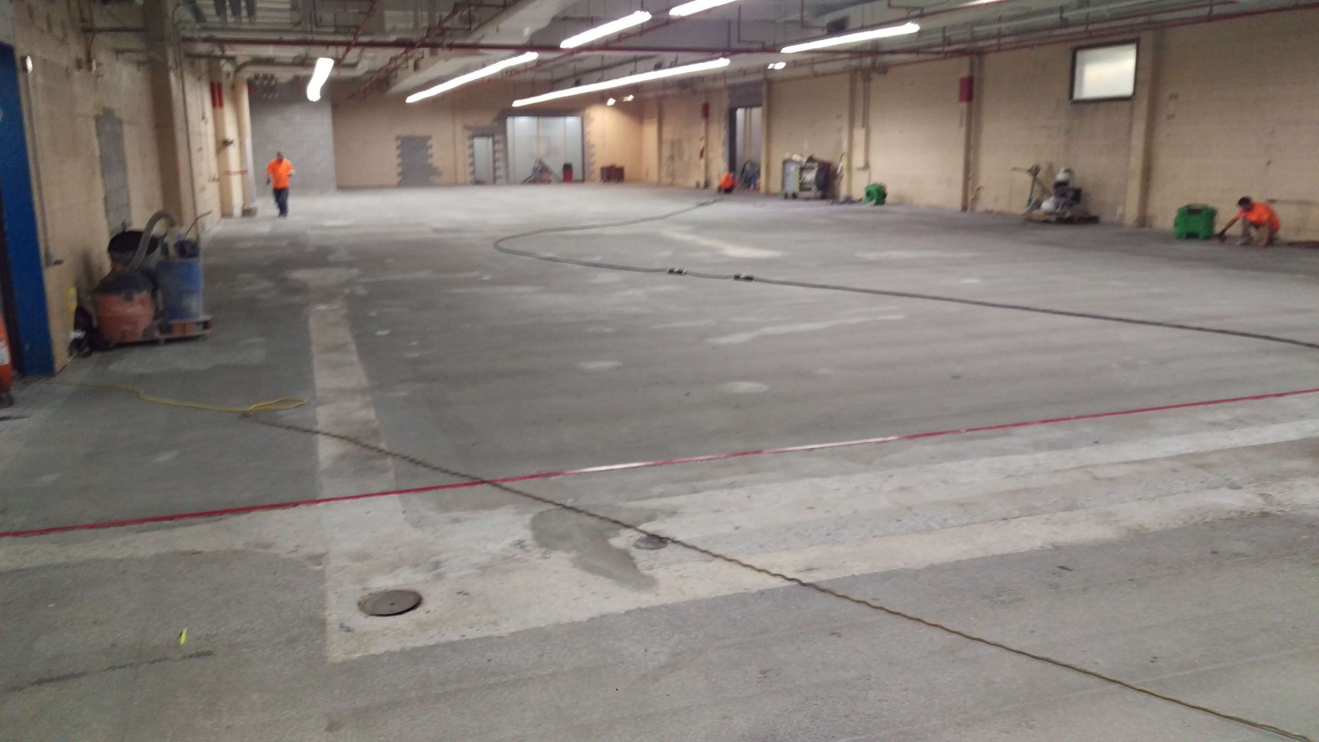 A large empty warehouse with a concrete floor.
