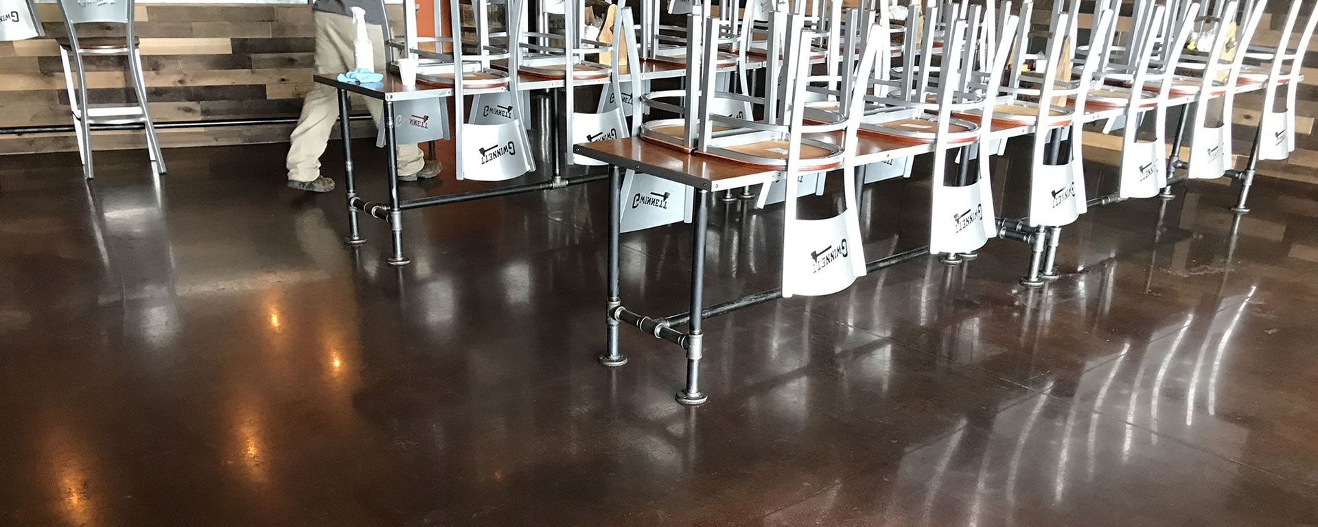 A row of tables and chairs are lined up in a room.
