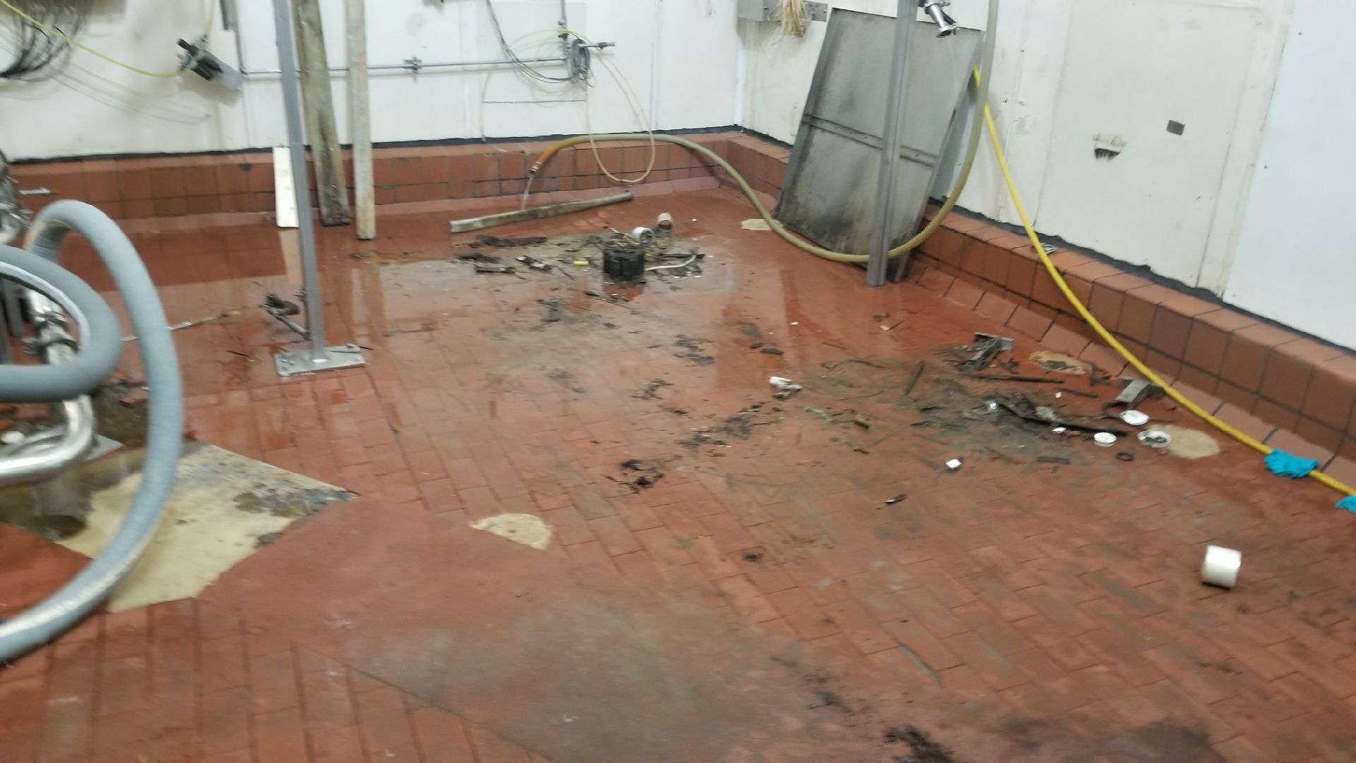 A dirty room with a vacuum cleaner on the floor.