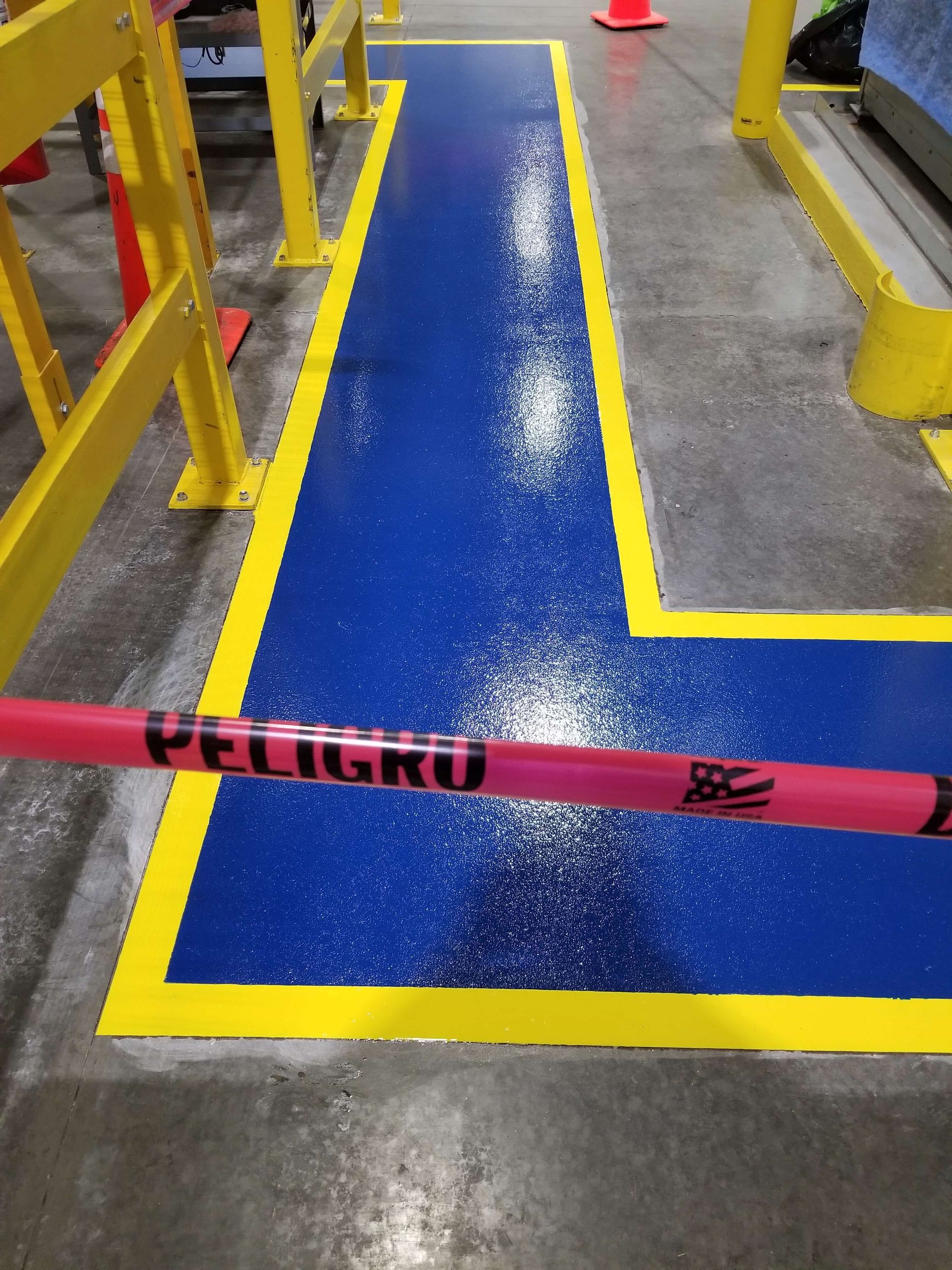 Blue painted walkway with yellow borders. Pink 