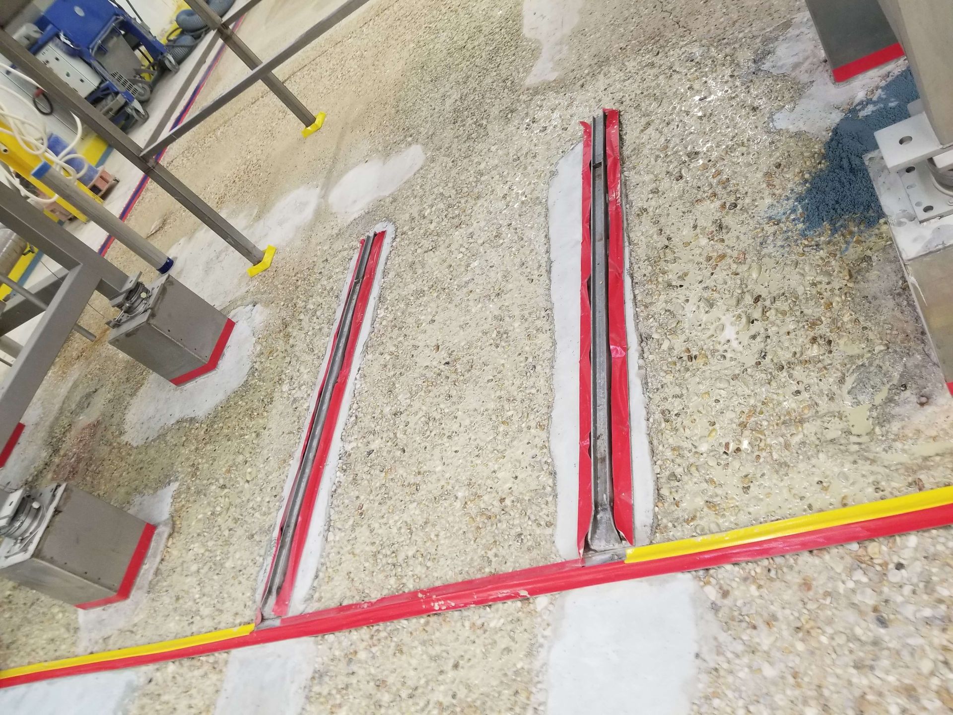 A concrete floor with a red and yellow stripe on it.