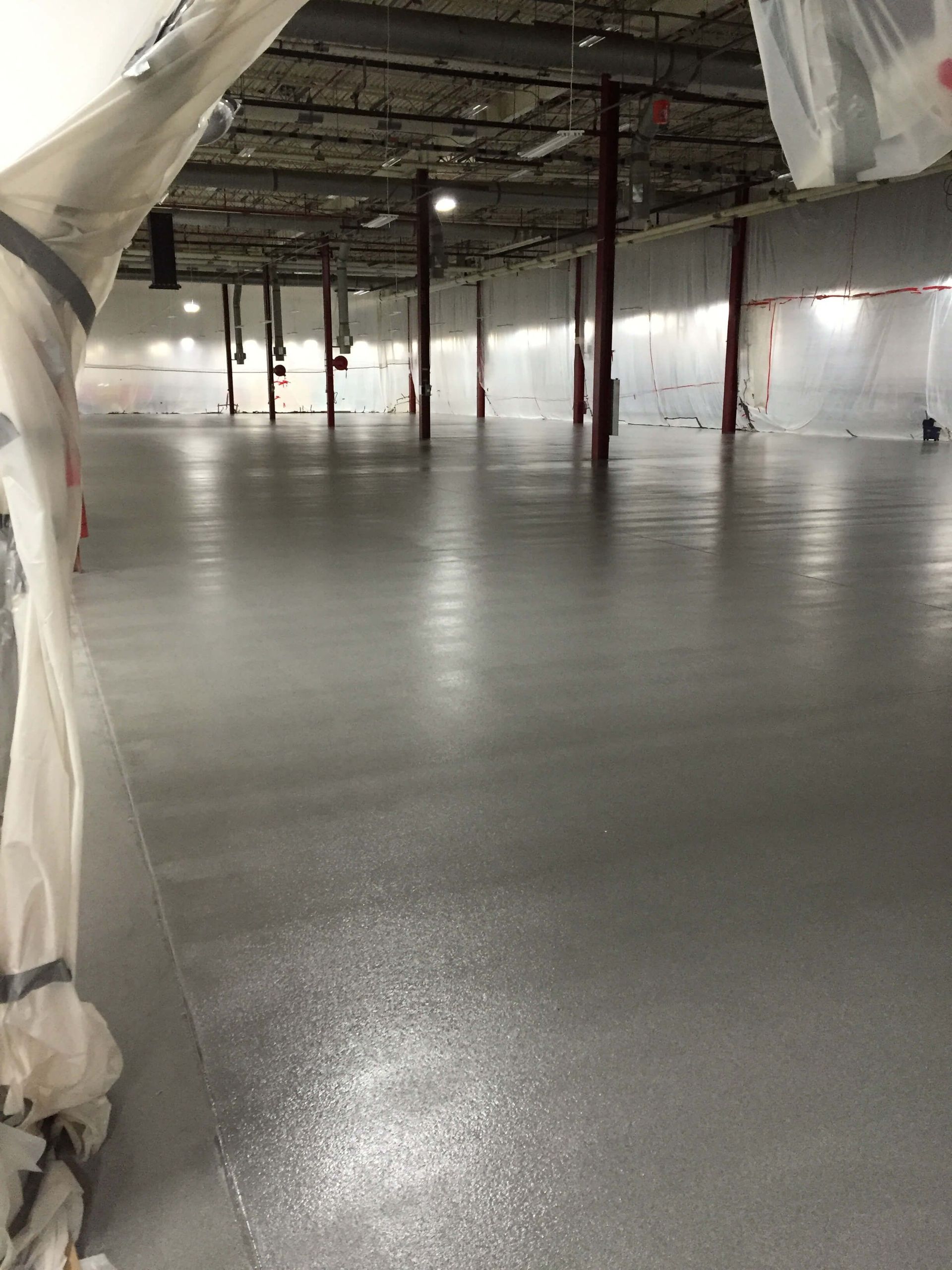 A large empty warehouse with a concrete floor