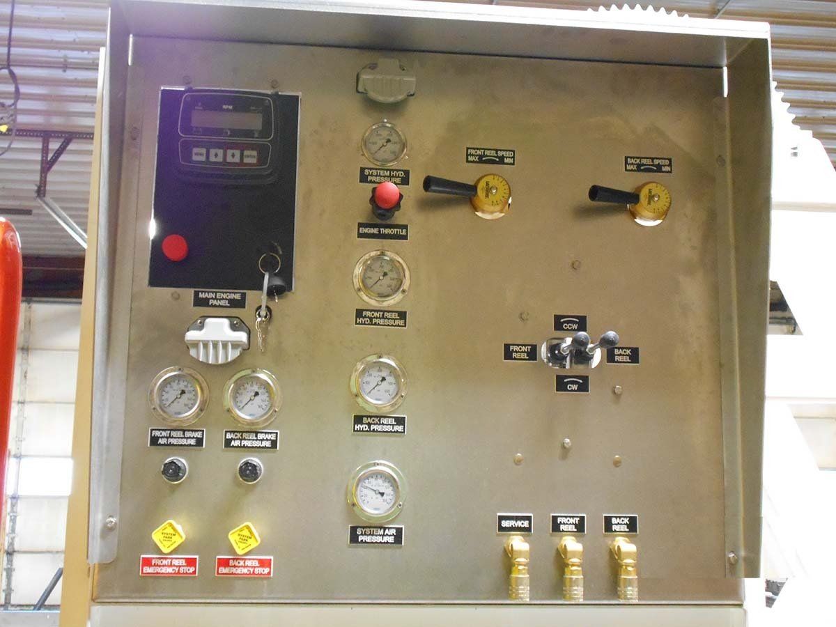 A stainless steel control panel with buttons and gauges