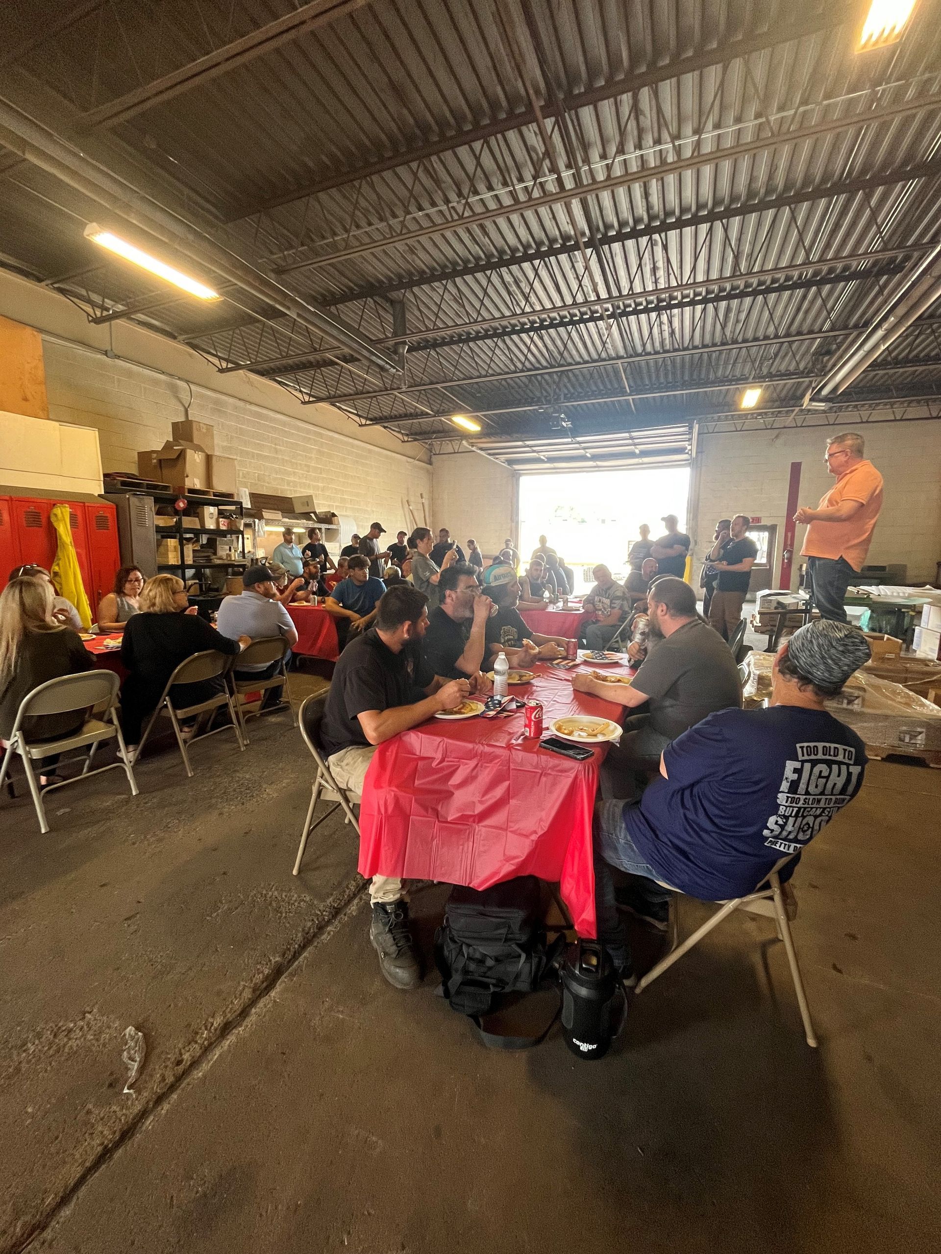 A group of people are sitting at tables in a room.