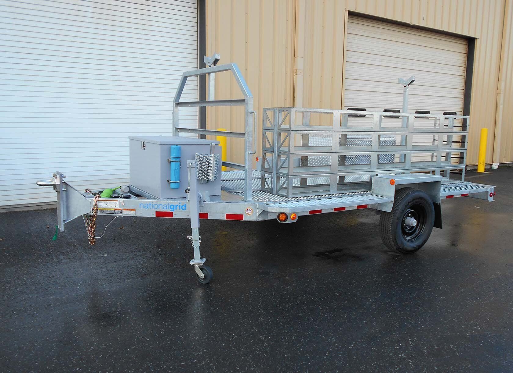A trailer is parked in front of a garage door