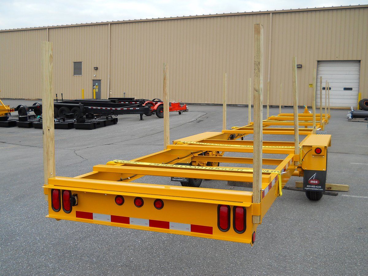 A yellow trailer is parked in front of a building