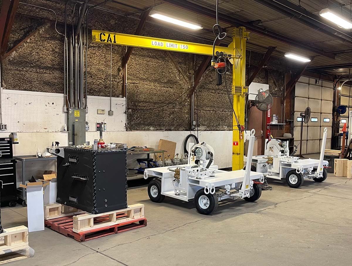 A warehouse filled with lots of machinery and a crane.