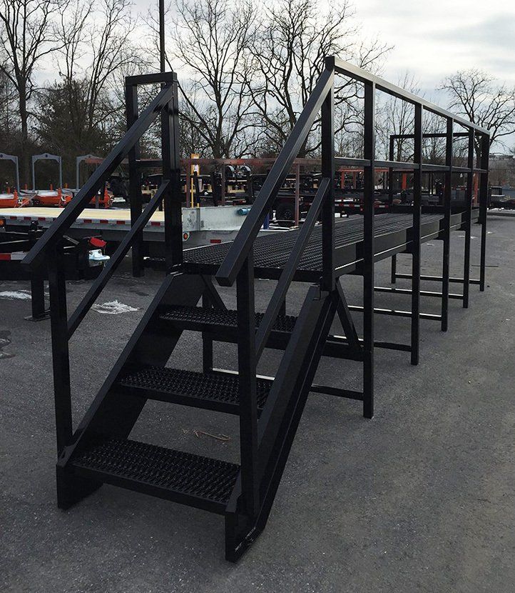 A set of black metal stairs leading up to a platform