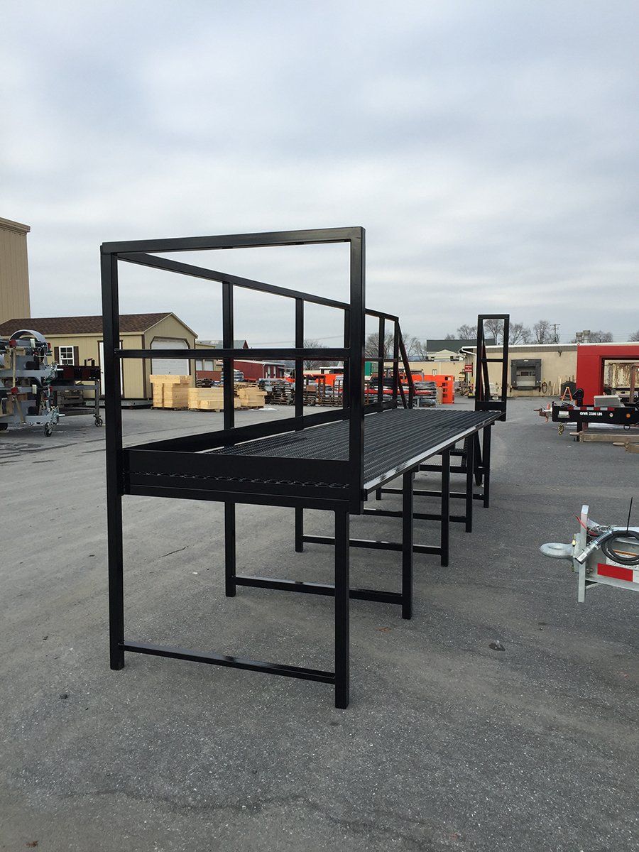 A large metal structure is sitting in the middle of a parking lot