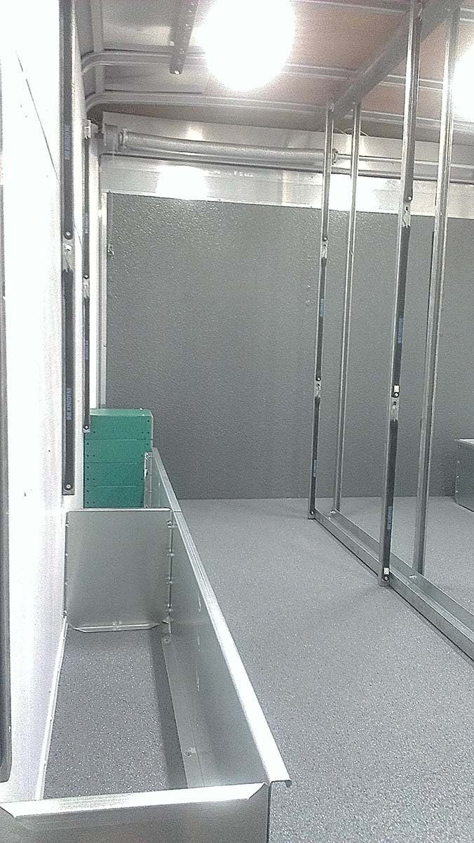 A row of mirrors in a room with a green box in the middle.
