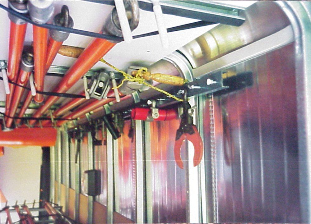 A bunch of pipes are hanging from the ceiling