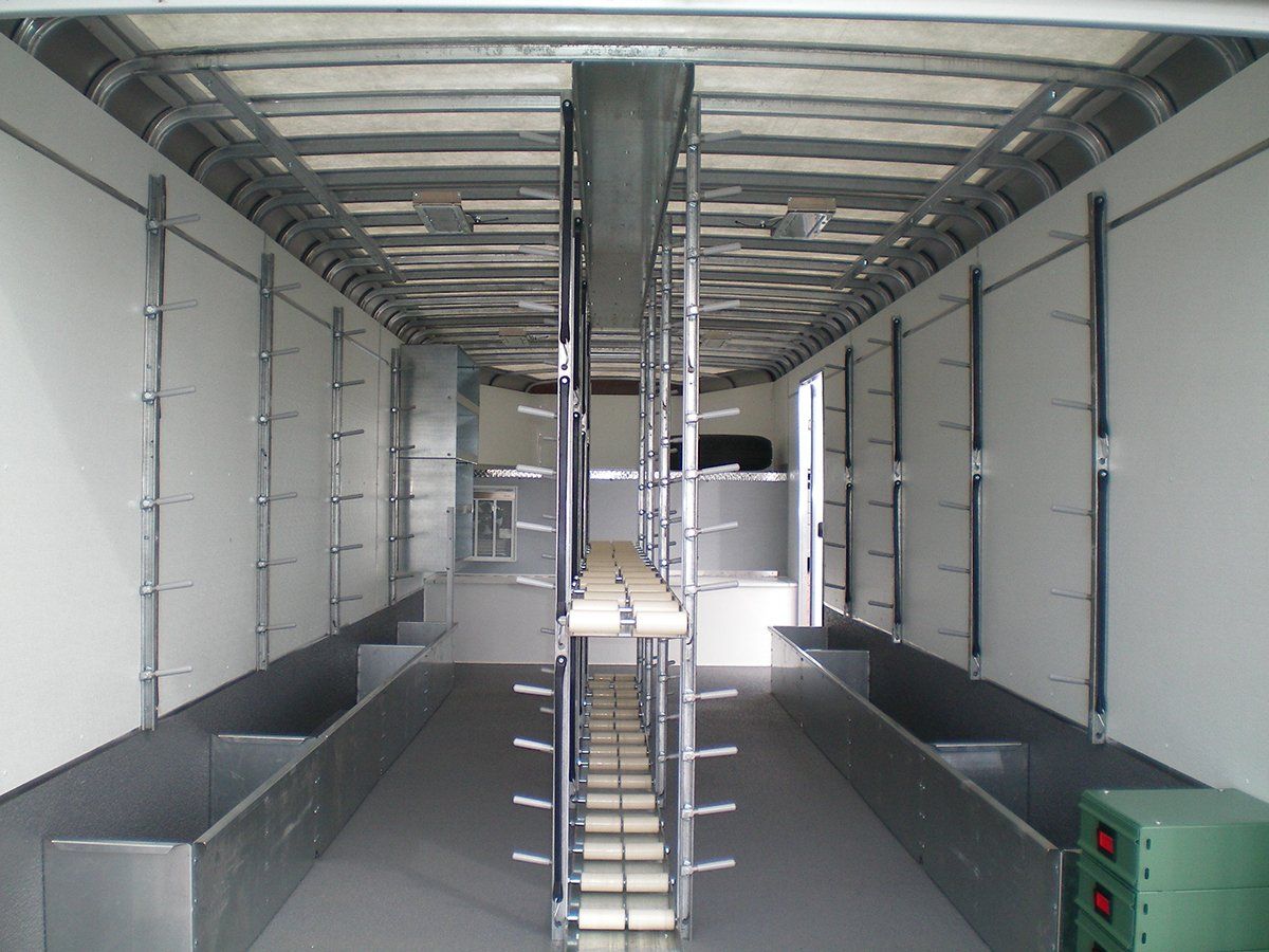 The inside of a truck with a ladder going up to the ceiling