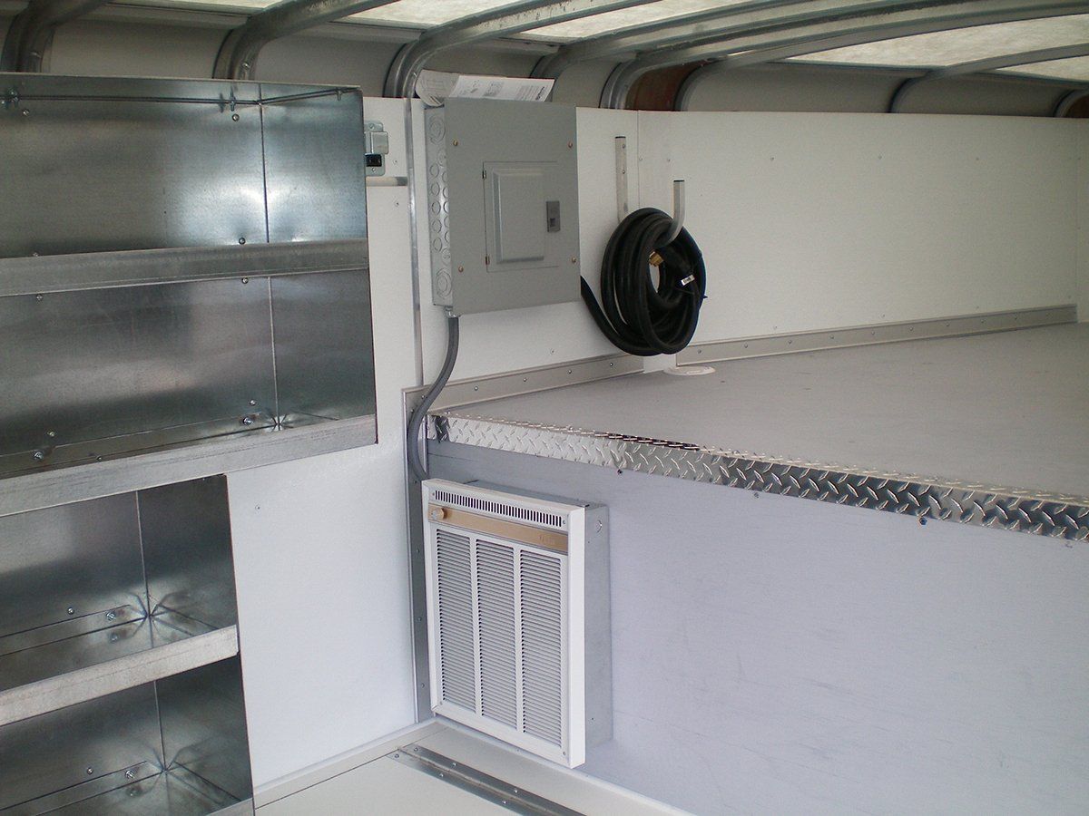 There is a hose hanging on the wall next to a fan.