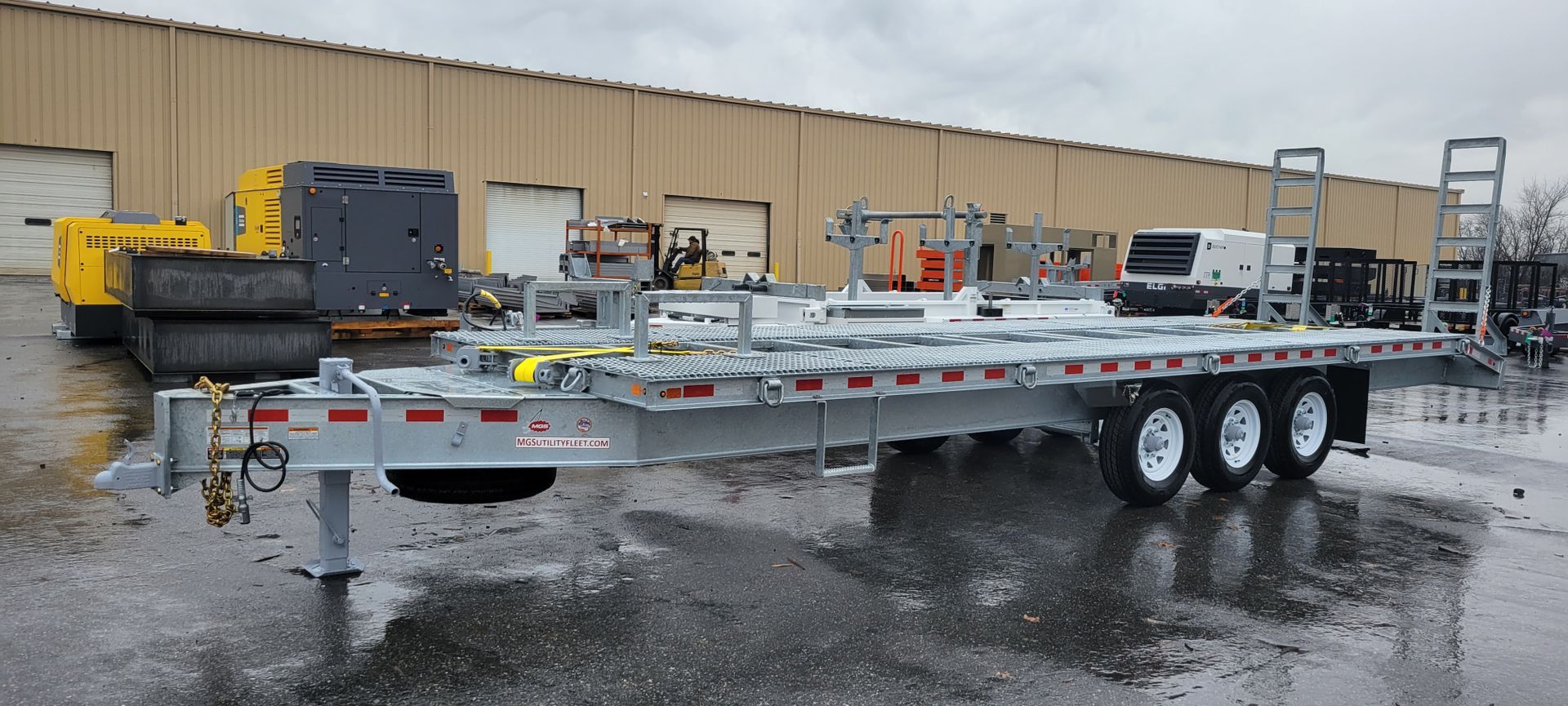 A trailer is parked in front of a building in a parking lot.