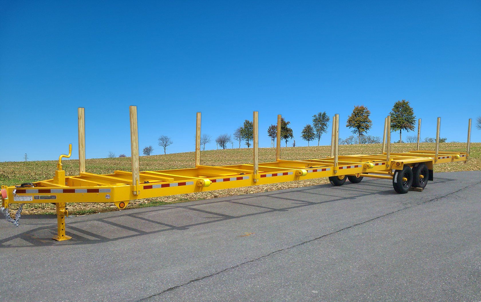 A yellow trailer is parked on the side of the road