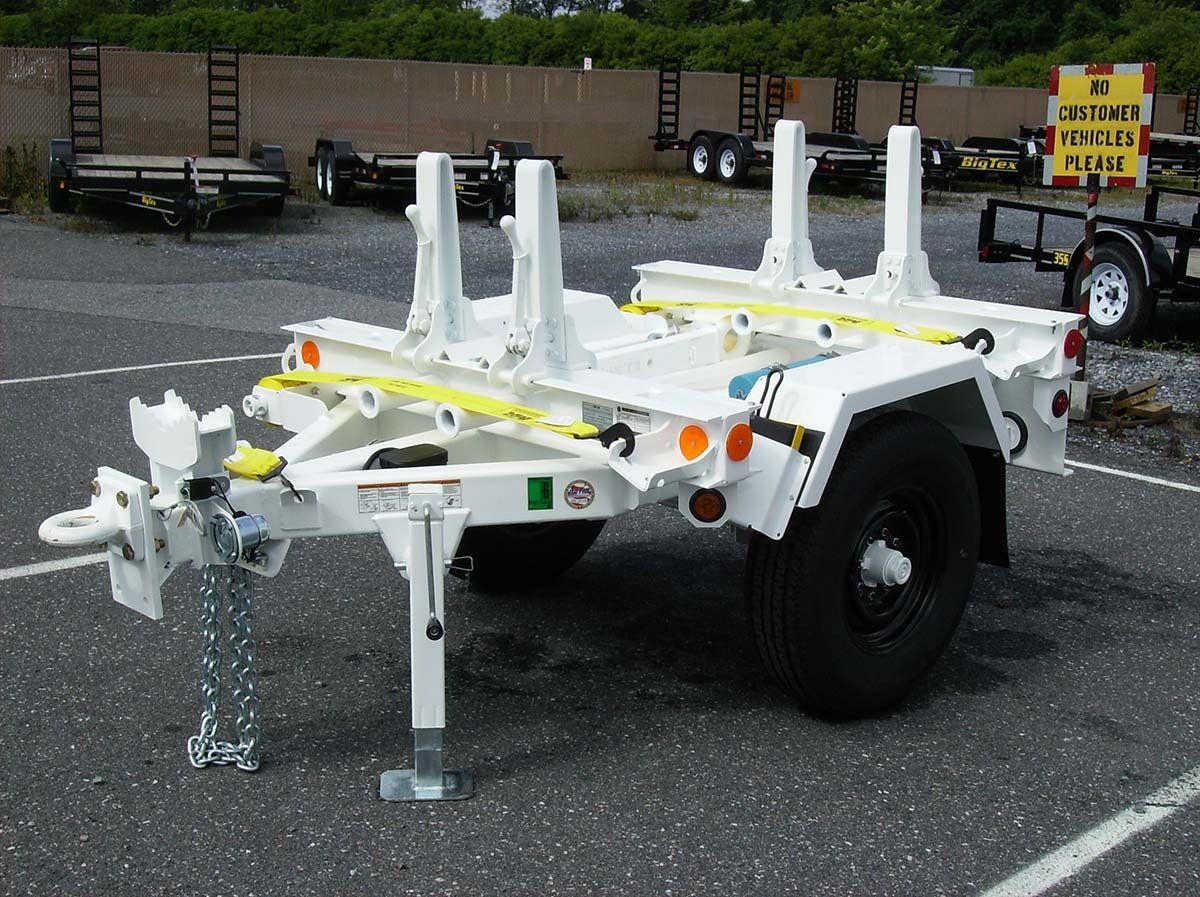 A white trailer is parked in a parking lot