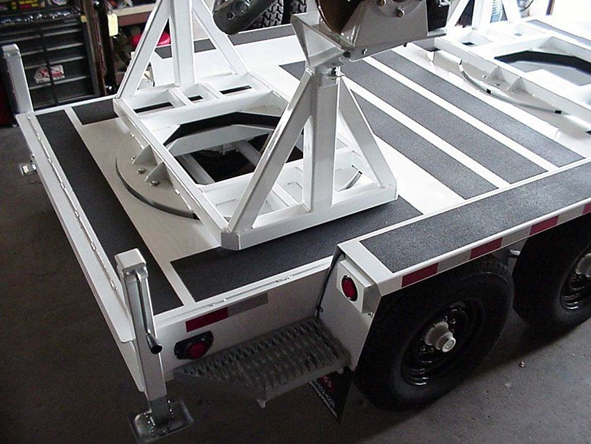 A white trailer with black stripes on the floor