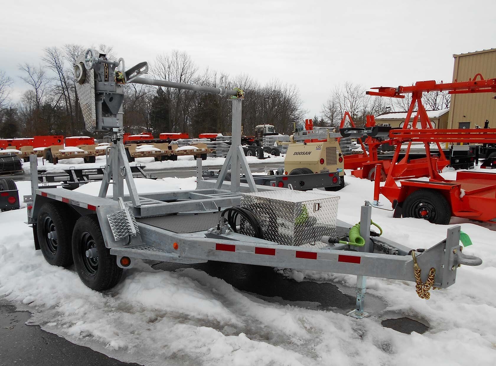 A trailer is parked in the snow in front of a building