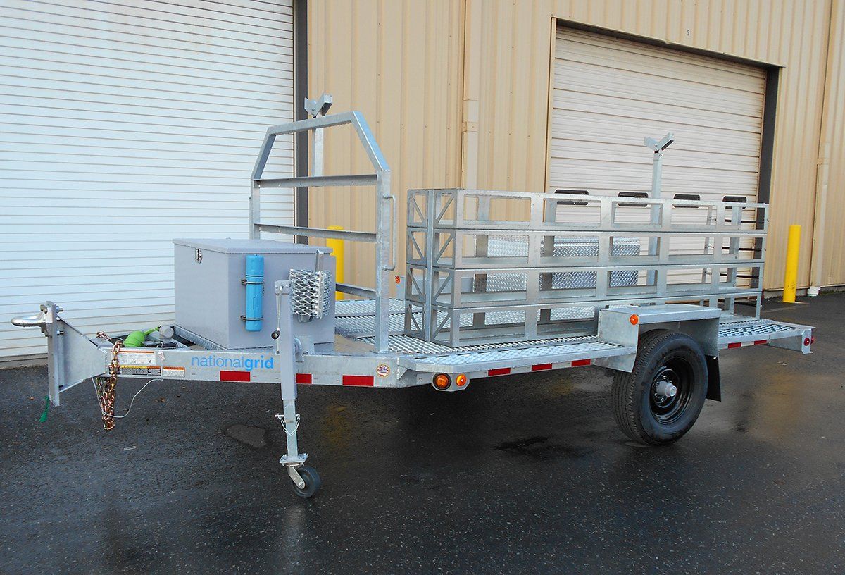 A trailer is parked in front of a garage door