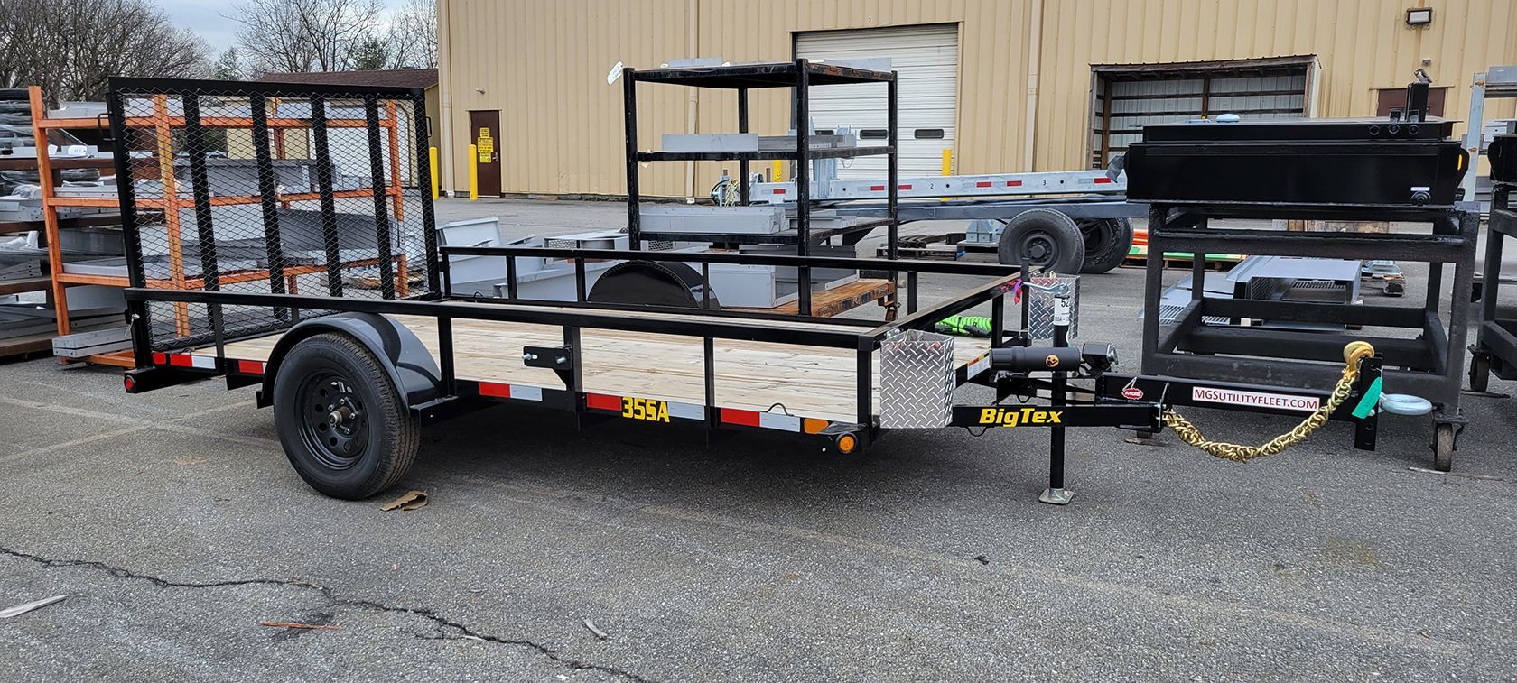 A trailer is parked in front of a building in a parking lot.