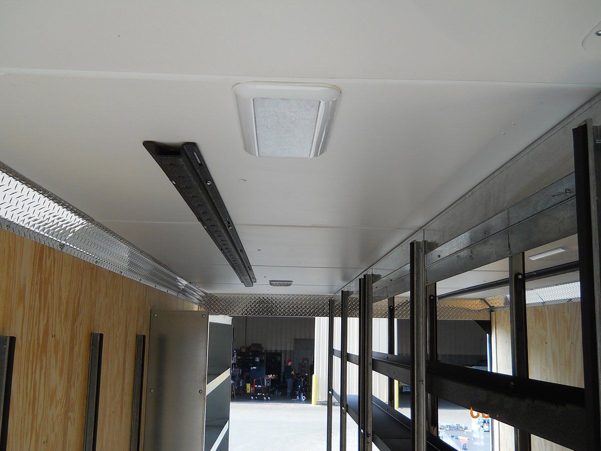 The inside of a trailer with a light on the ceiling.