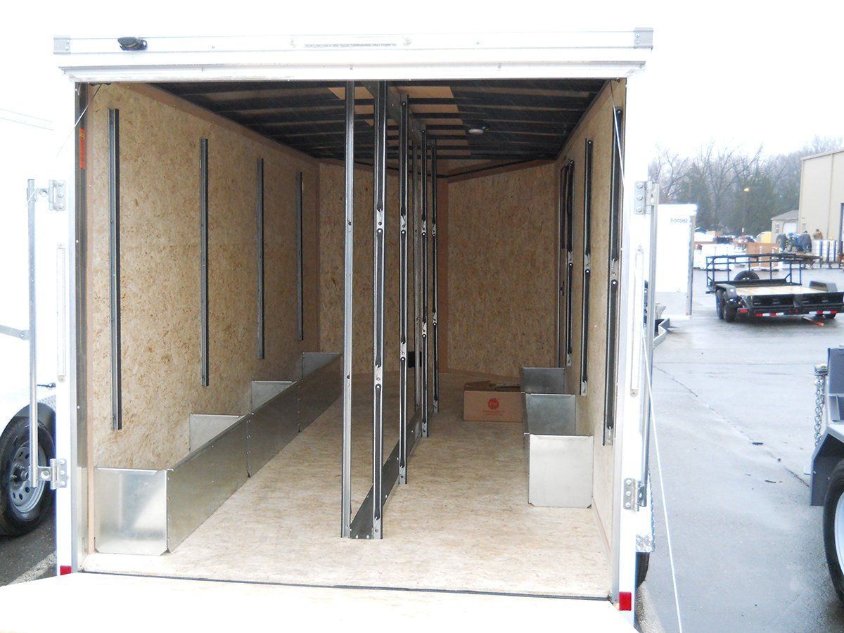 The inside of an empty trailer with the door open