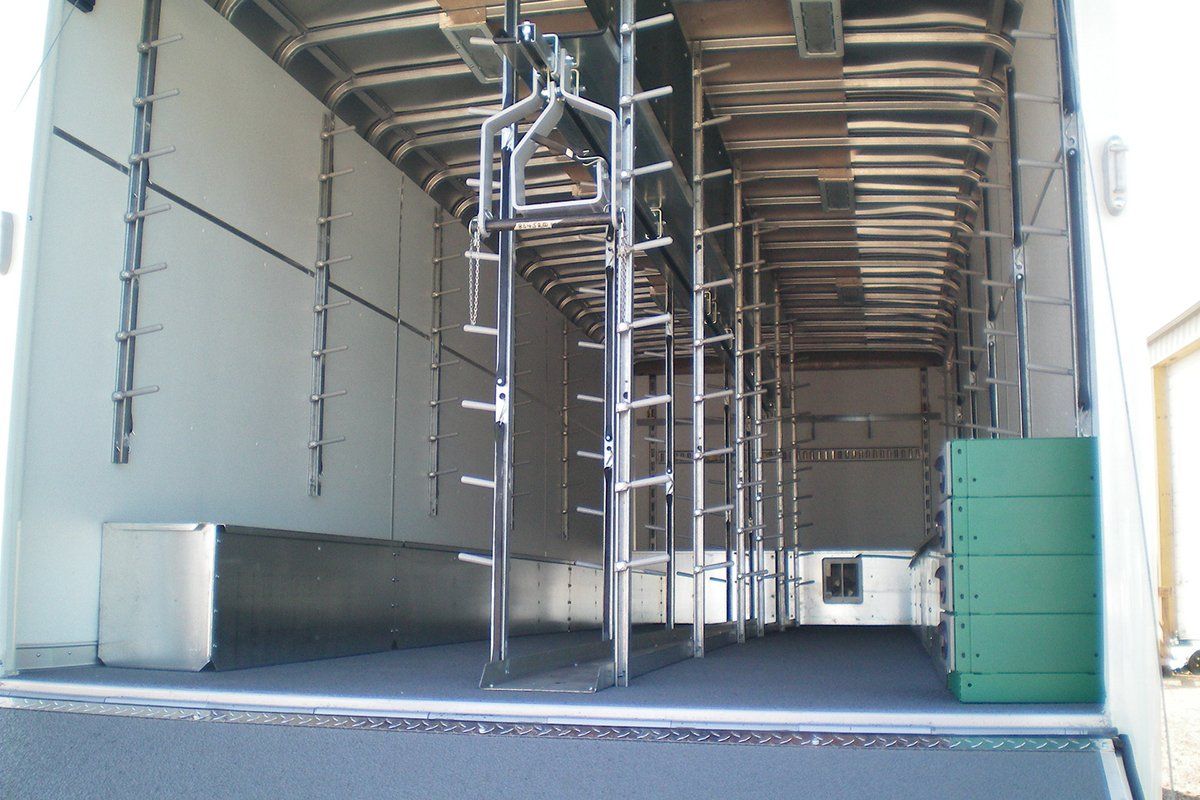 The inside of a white truck with a green box in the back