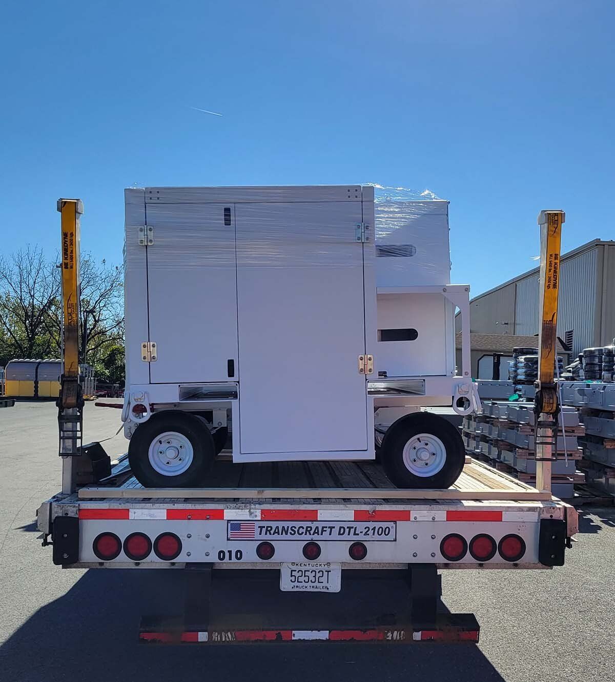 A truck with a box on the back that says transport on it